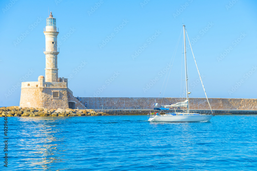 Sailing boat at the lighthouse of Chania, Crete, Greece Sailing boat at the lighthouse of Chania, Crete, Greece