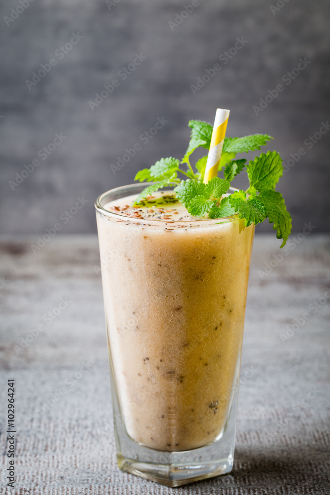 Banana and lemon smoothie, on the grey background. Banana and lemon smoothie, on the grey background.