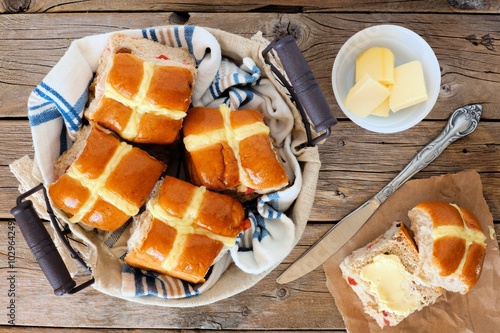 Easter Hot Cross Buns, overhead scene on a rustic wood background