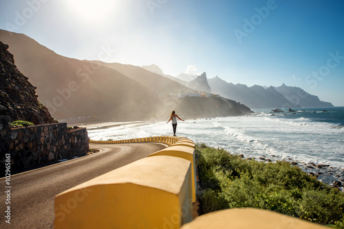 Woman walking near the mountain road photo