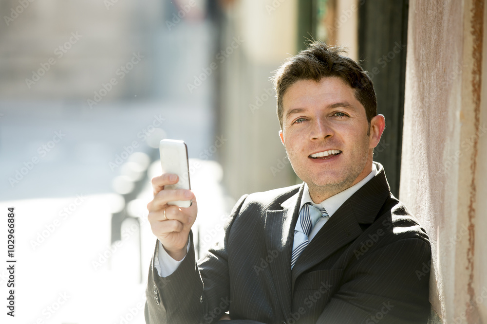 busy businessman in suit and tie using mobile phone sending message or consulting internet busy businessman in suit and tie using mobile phone sending message or consulting internet