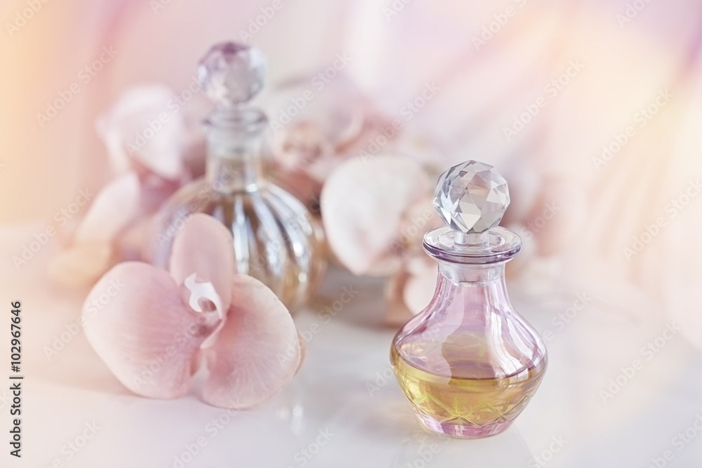 perfume and aromatic oils bottles surrounded by flowers perfume and aromatic oils bottles surrounded by flowers