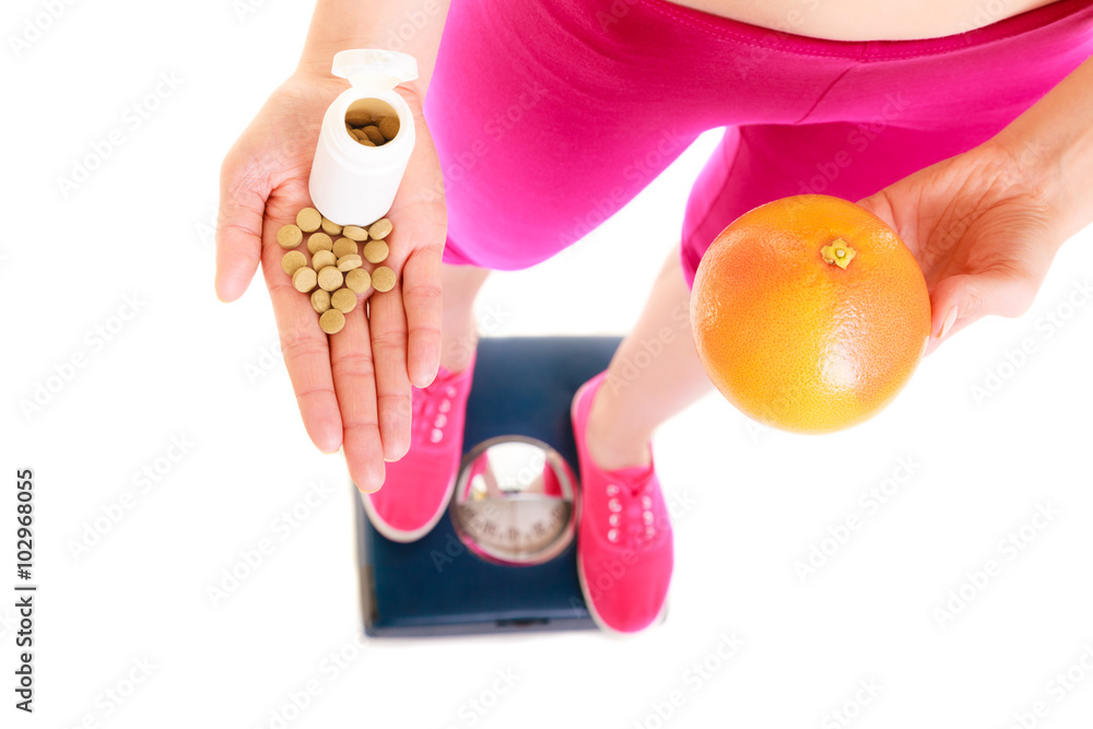 Obraz premium Woman holding vitamins and apple. Health care.