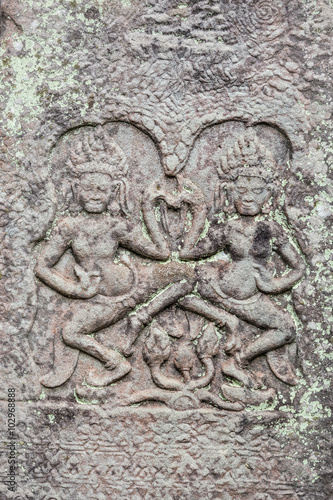 Historic Khmer bas-relief showing dancing Hindu godesses at Bayon temple, Cambodia