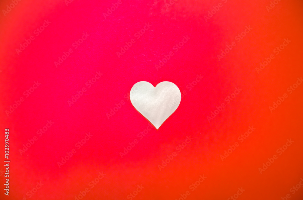 White love heart in the middle on a red background, bright red background with a heart White love heart in the middle on a red background, bright red background with a heart