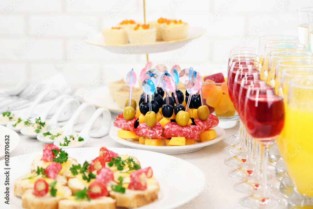Set of cold snacks, canape, beverages, closeup Set of cold snacks, canape, beverages, closeup