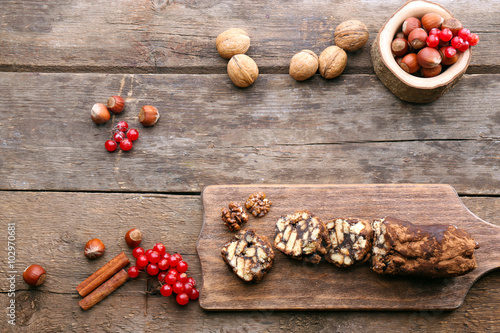 Chocolate salami on a chopping board over wooden background