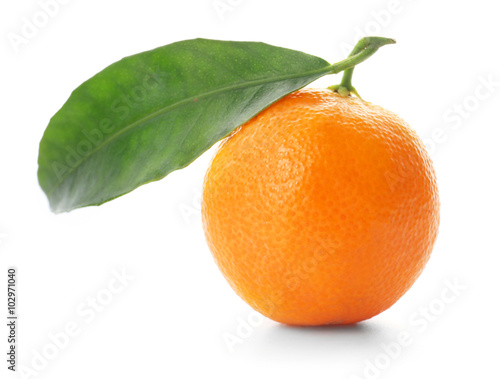 Ripe tangerine with green leaf isolated on white
