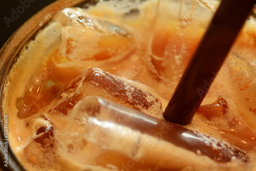 Macro shot of brown straw in ice coffee