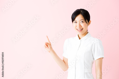 portrait of asian nurse isolated on pink background