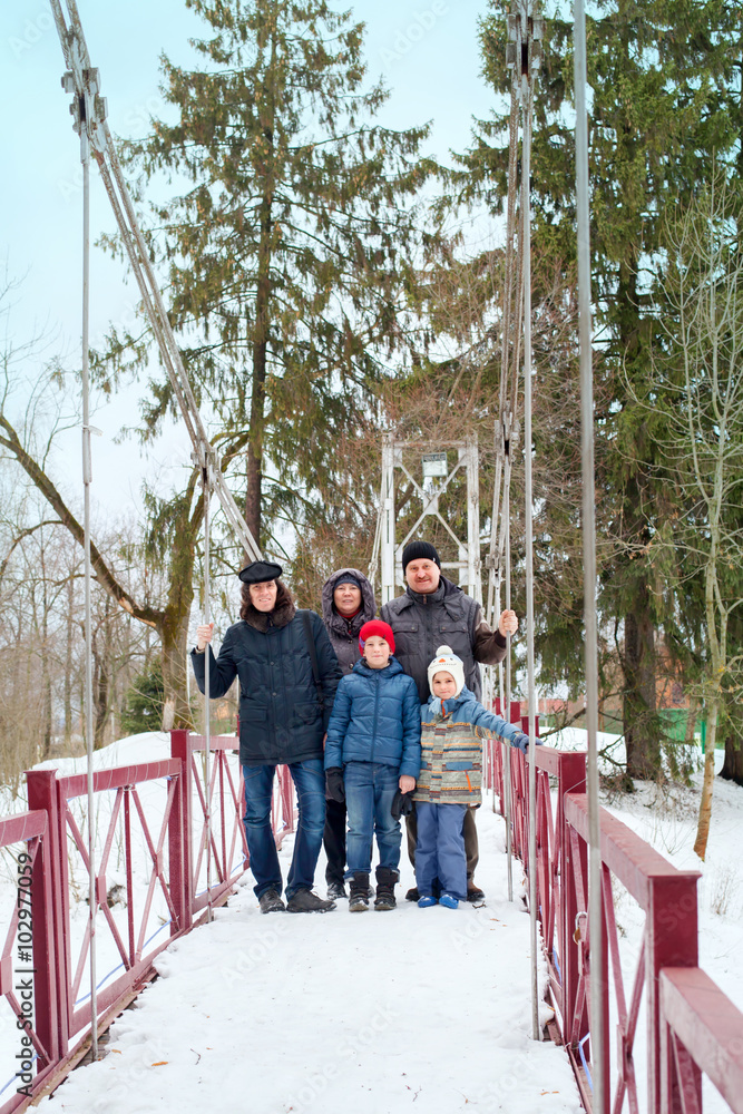 family of three generations for a walk in winter