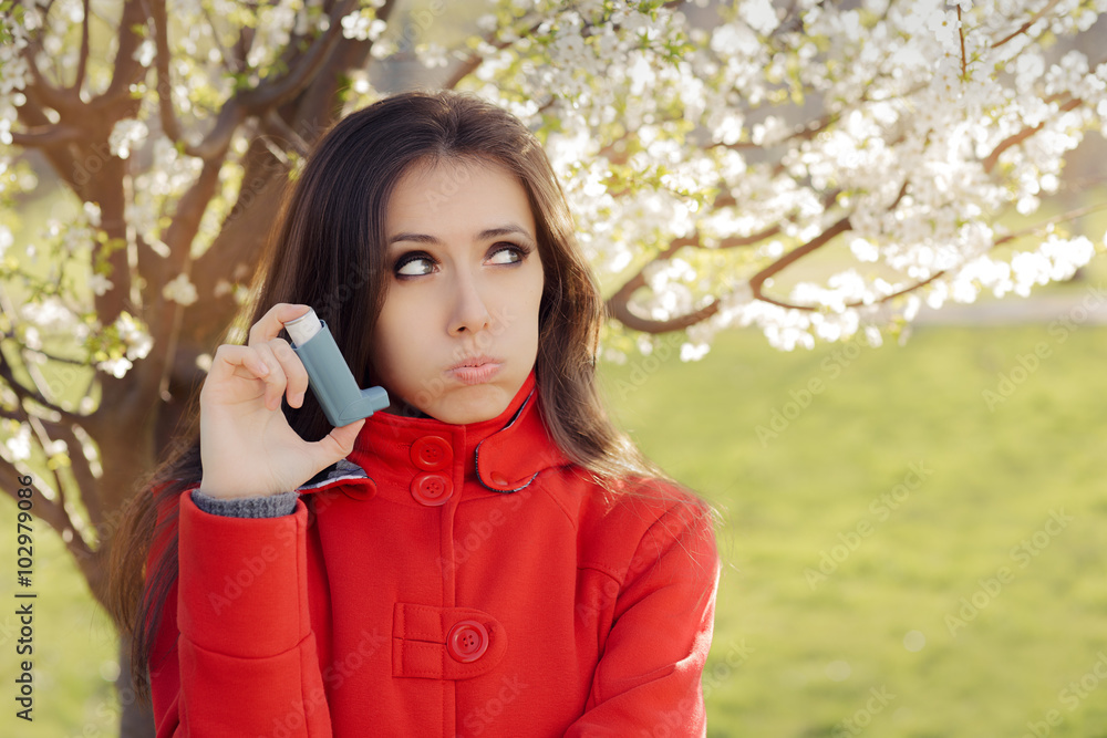 Upset Woman with Inhaler in Spring Blooming Decor Upset Woman with Inhaler in Spring Blooming Decor