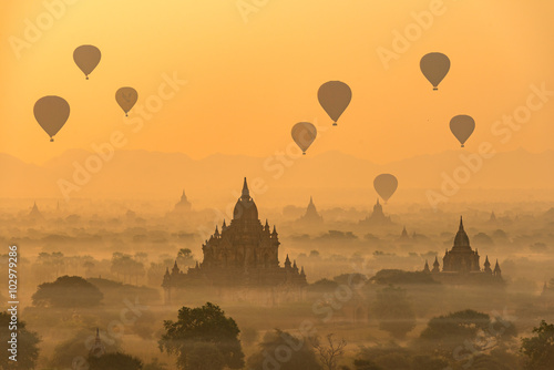Hot air balloons float over pagodas field