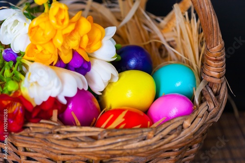 Easter eggs and freesia in basket