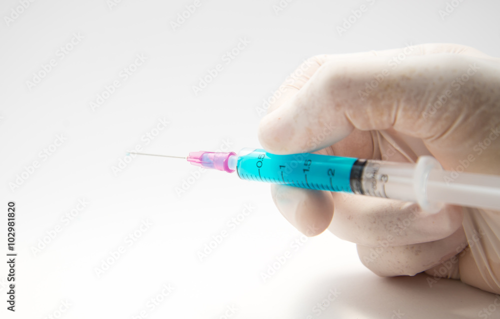 Syringe, medical injection in hand. Syringe, medical injection in hand.