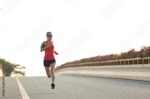 young fitness woman runner running on road © lzf