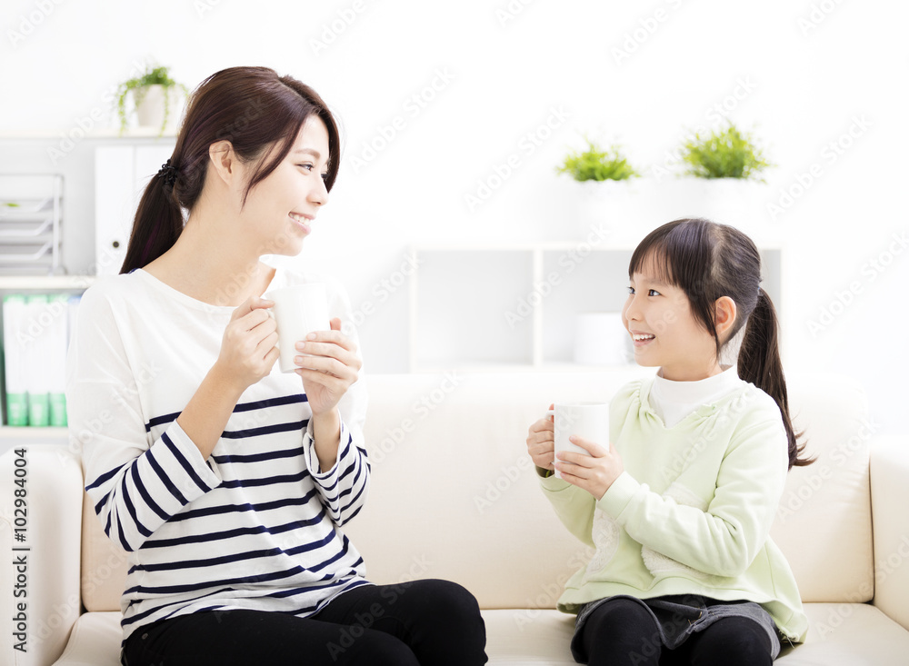 smiling mother and daughter on the sofa smiling mother and daughter on the sofa