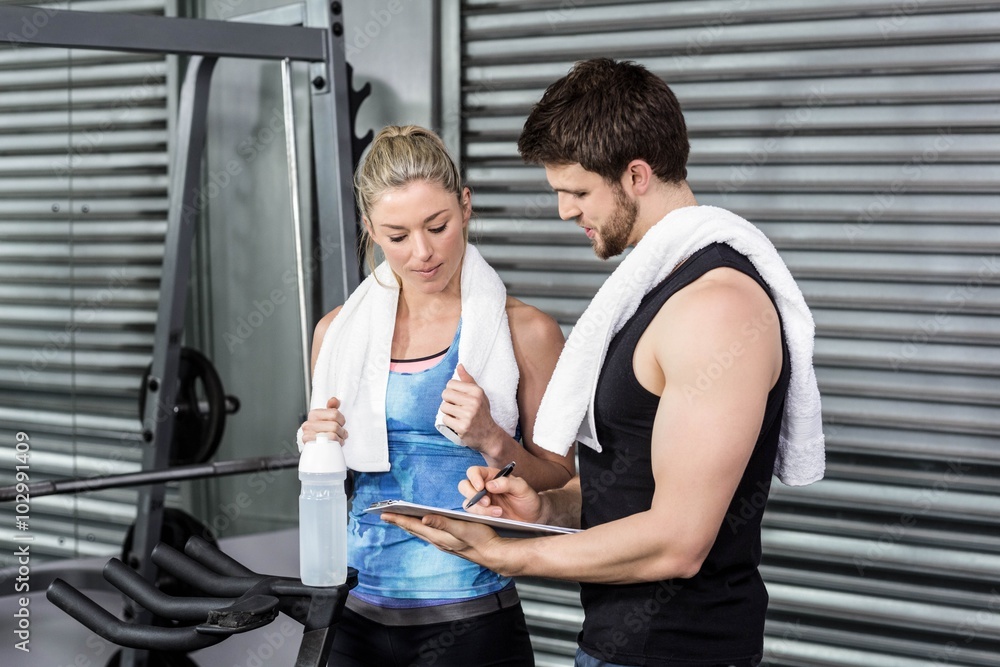 Fototapeta premium Smiling fit couple taking notes 