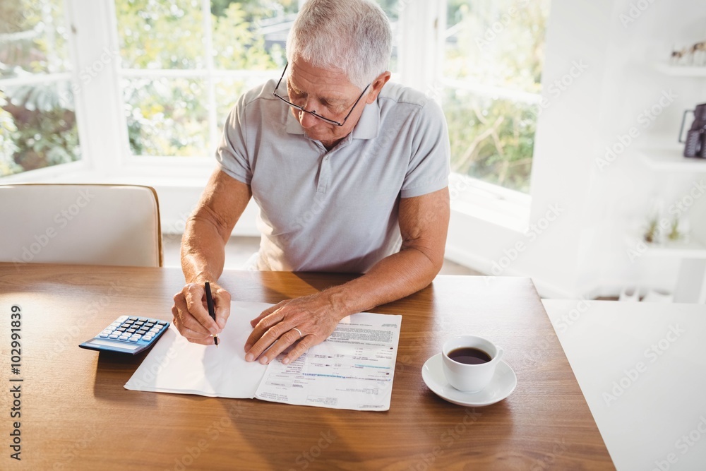 Worried senior man with tax documents Worried senior man with tax documents