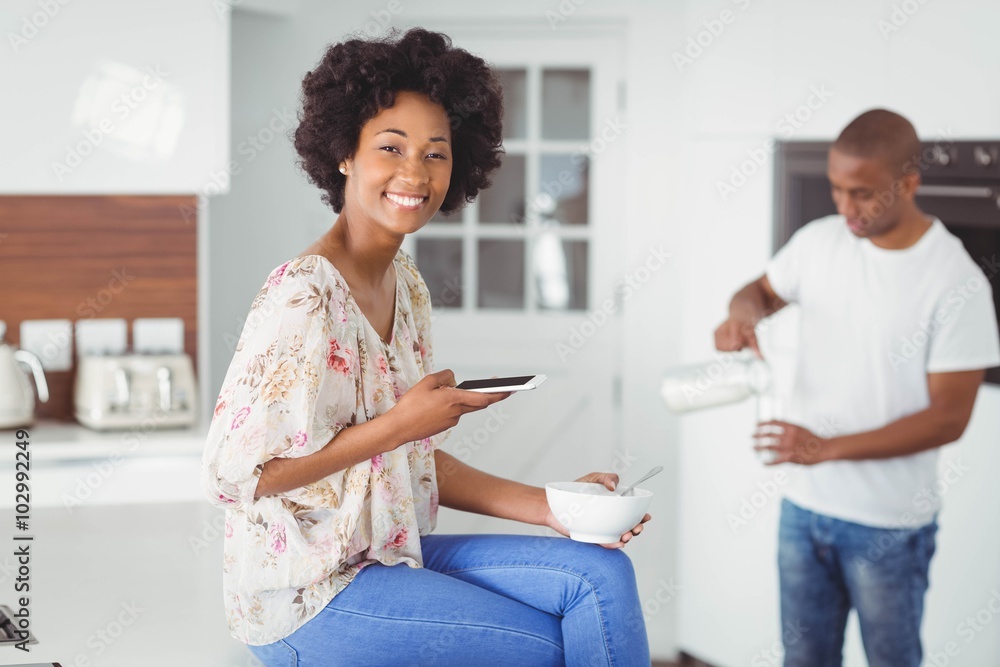 Happy couple eating breakfast and using smartphone Happy couple eating breakfast and using smartphone
