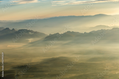 Layer of mountains and mist at sunset time
