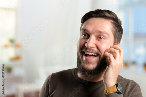 Happy young man talking on cell phone