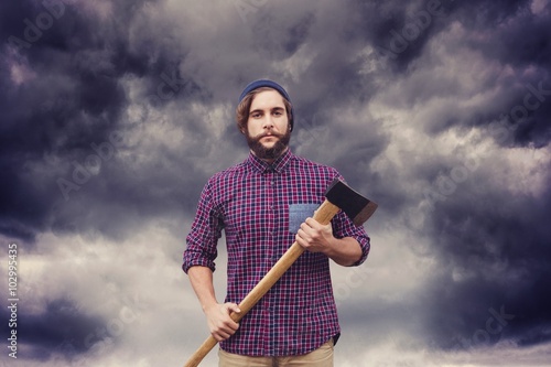 Composite image of portrait of hipster with axe photo