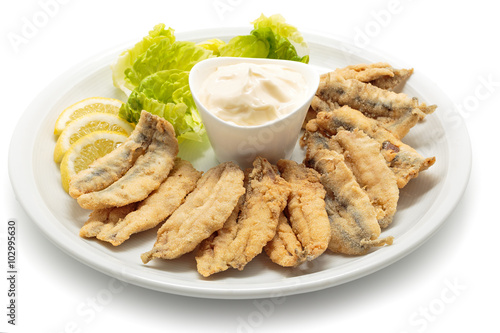 Fried anchovies with salad and mayonnaise