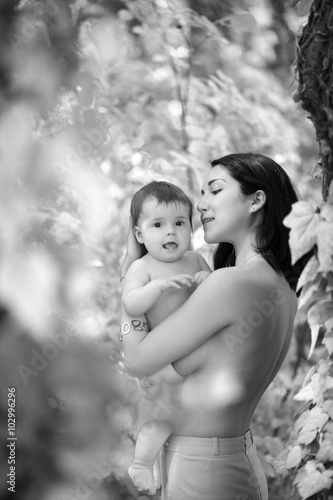 Baby and mother hugging topless