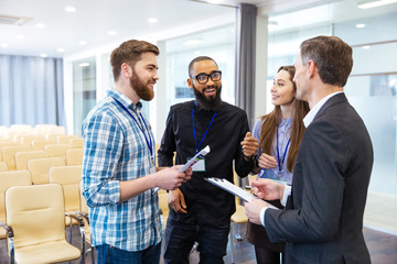 Inspired young people discussing new project in conference room
