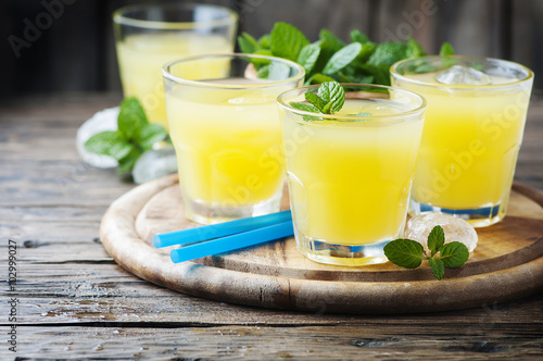 Yellow fresh cocktail with mint and ice