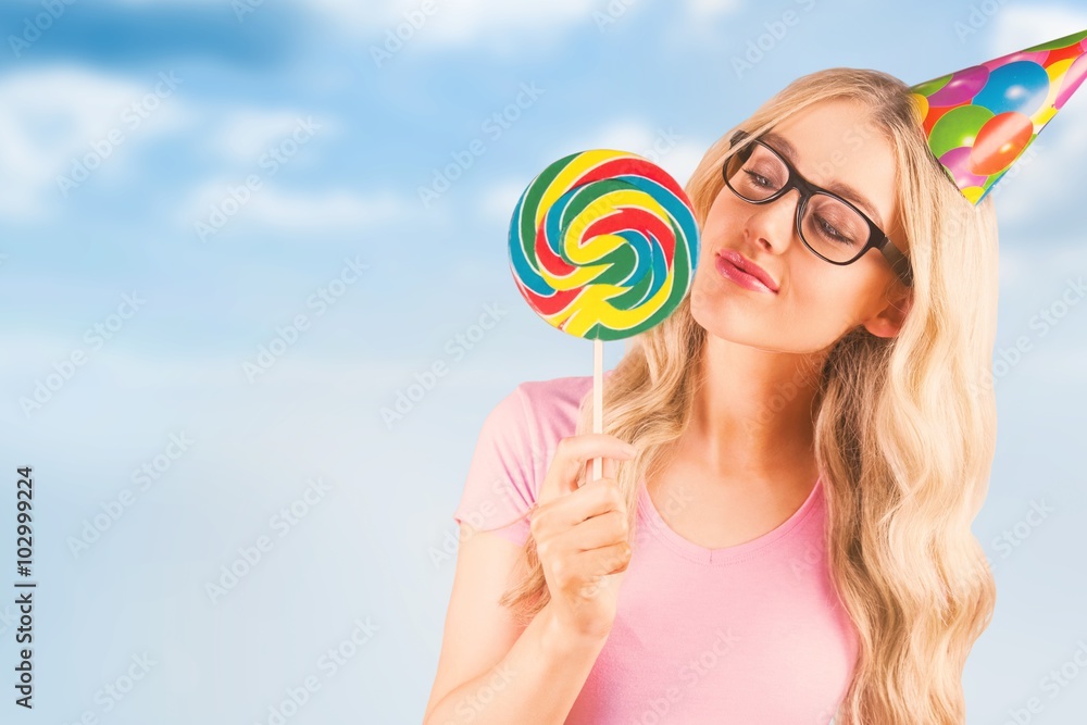 Composite image of a beautiful hipster holding a giant lollipop 