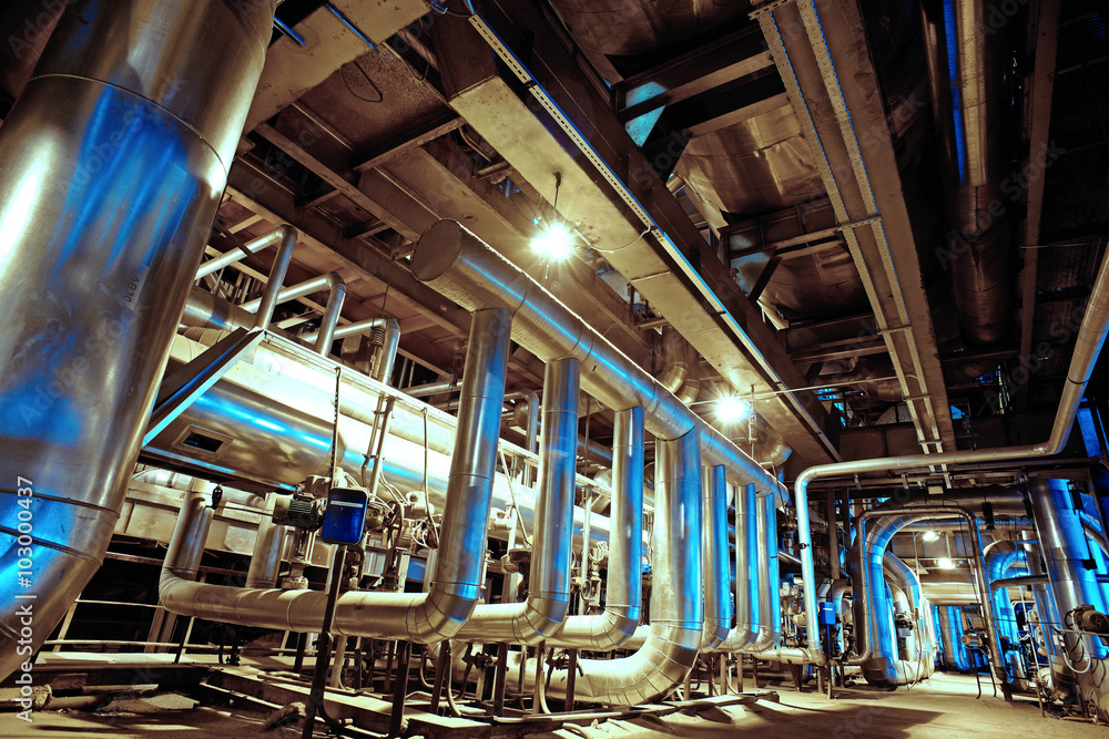 Equipment, cables and piping as found inside of a modern industr