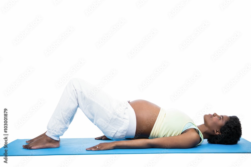 Pregnant woman doing exercise on mat Pregnant woman doing exercise on mat