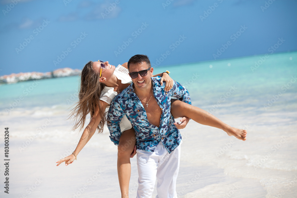 Beach couple having fun laughing on Caribbean holidays. Beach couple having fun laughing on Caribbean holidays.