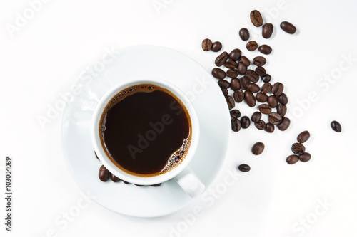 Cup of coffee with coffee beans isolated on white background.