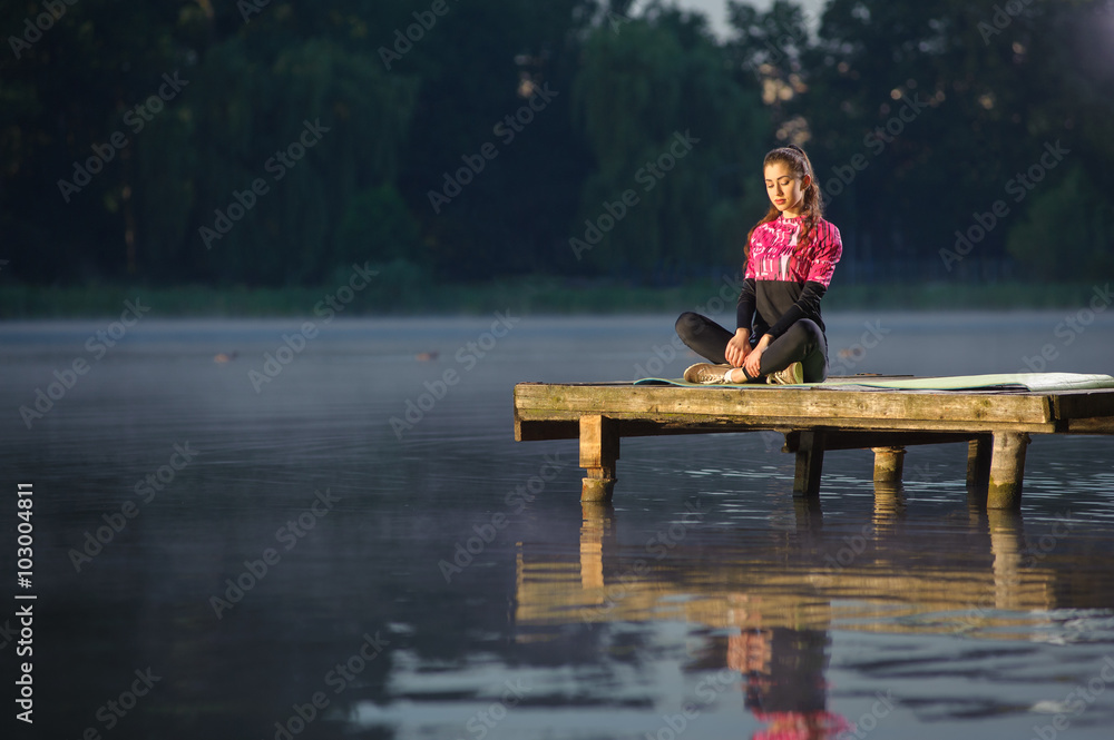 Beautiful young female sitting quietly with her legs crossed in Beautiful young female sitting quietly with her legs crossed in