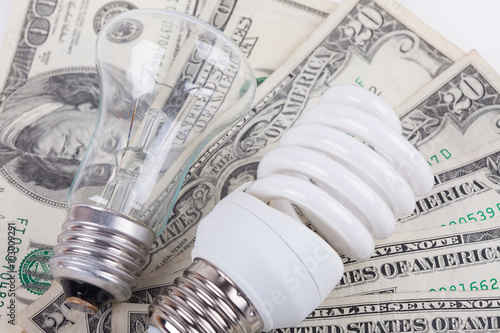 energy saving, traditional lamps and dollars closeup