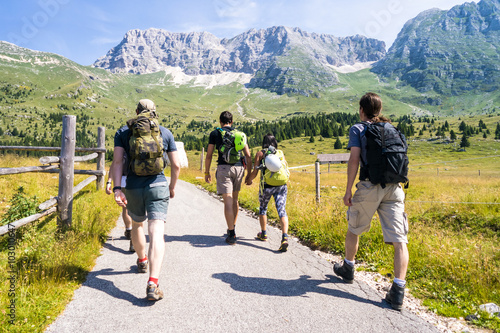 group of friends on a trip through the mountains, climbers before climbing to the top photo