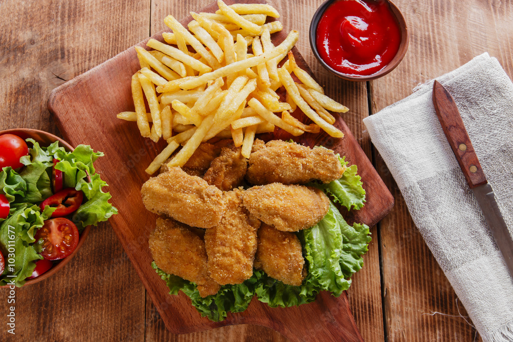 chicken wings fried in breadcrumbs with sauce and french fries chicken wings fried in breadcrumbs with sauce and french fries