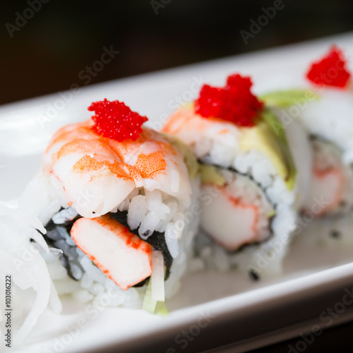 Sushi set, sushi roll with shrimp and sushi roll with avocado.