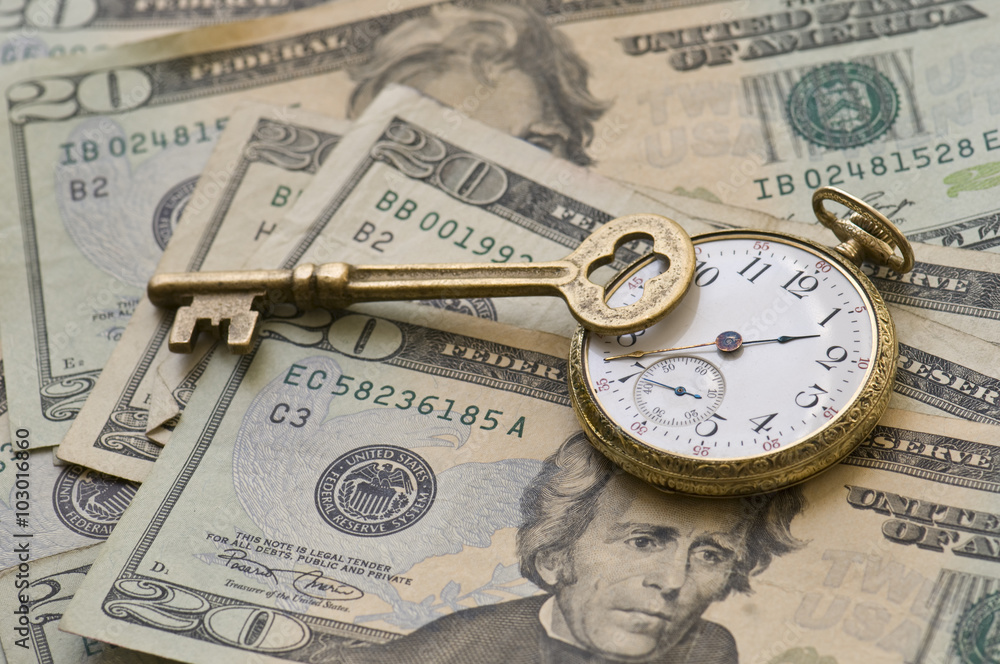 Market Timing. Business strategy concept image with a pocket watch, brass key atop, and US currency. Market Timing. Business strategy concept image with a pocket watch, brass key atop, and US currency.