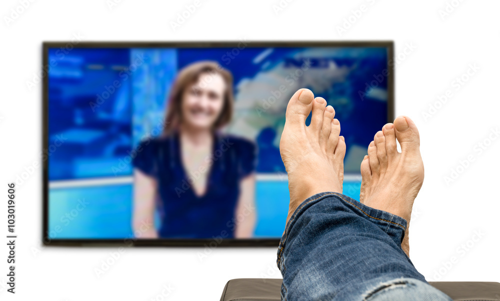 Man watching television news with feet on sofa - Uomo che guarda il  telegiornale con i piedi sul divano Stock Photo | Adobe Stock