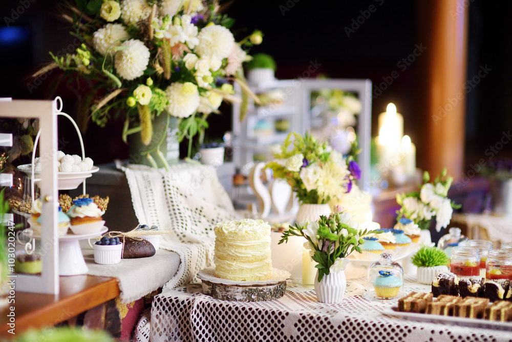 Decorated colorful cupcakes on a sweet table on some festive event