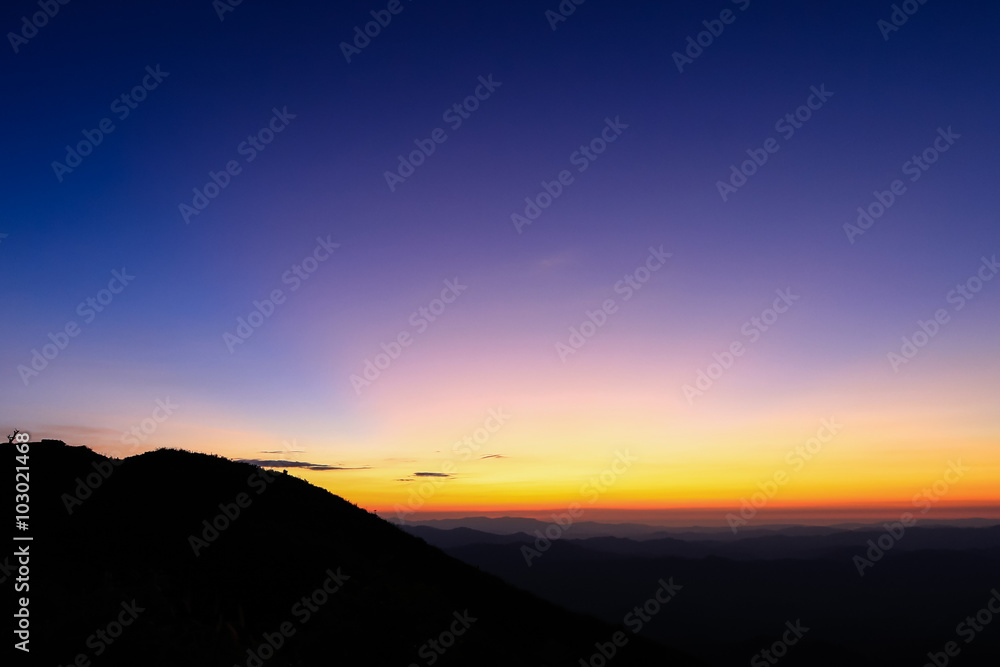 colorful sky above mountain just before sunrise