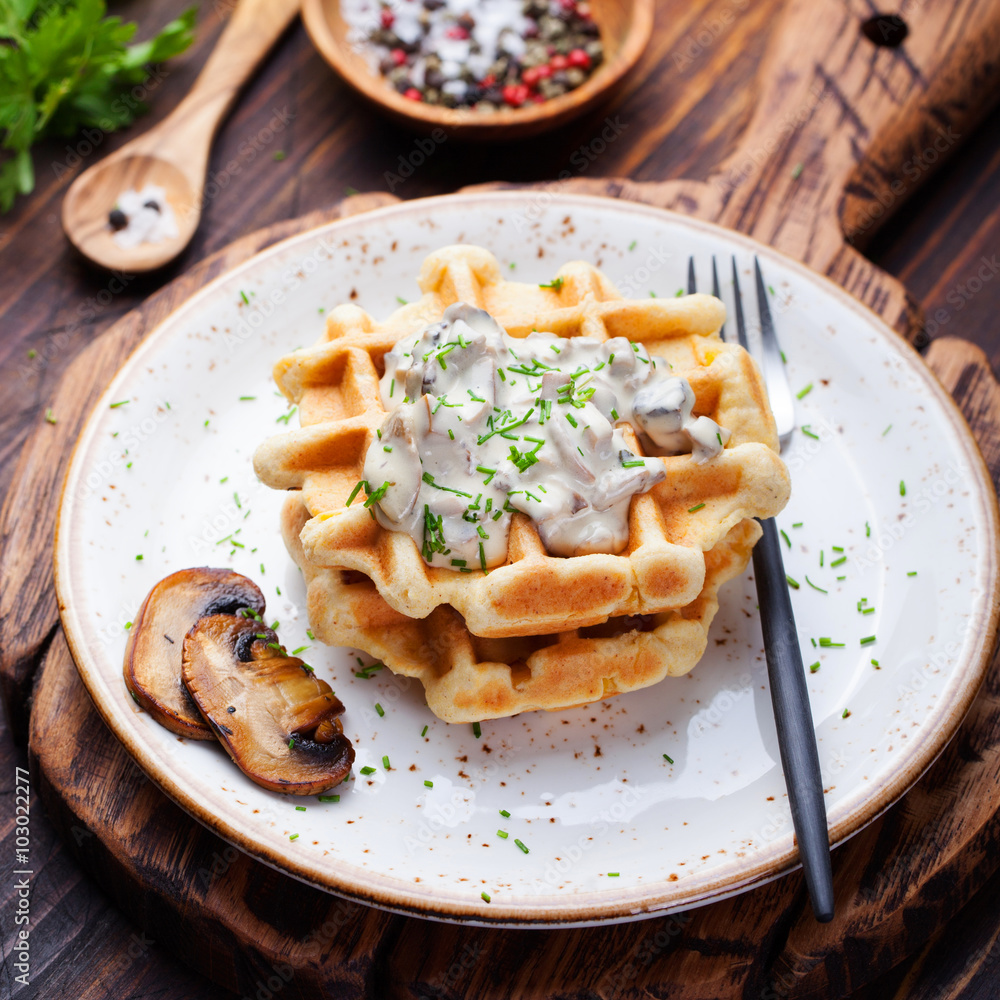 Savory waffles with corn and mushroom creamy sauce on a wooden background Top view Savory waffles with corn and mushroom creamy sauce on a wooden background Top view