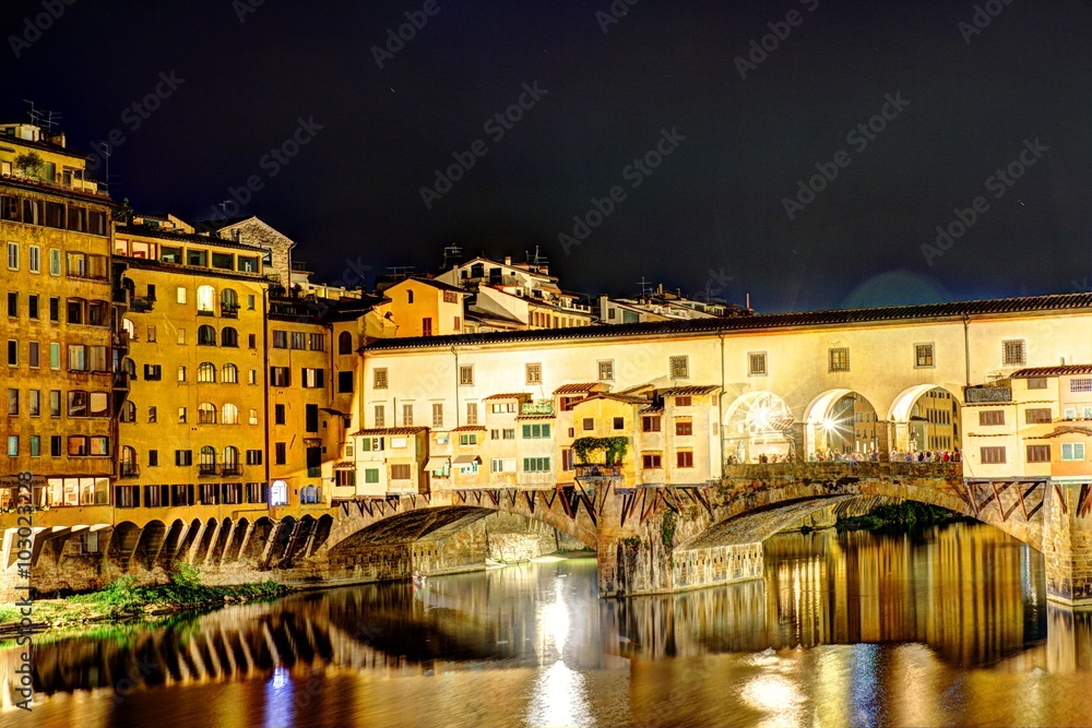 Florence, Italy - The golden bridge in Florence at night.