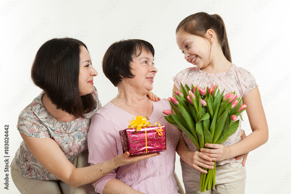 the daughter and the granddaughter give a bouquet the daughter and the granddaughter give a bouquet