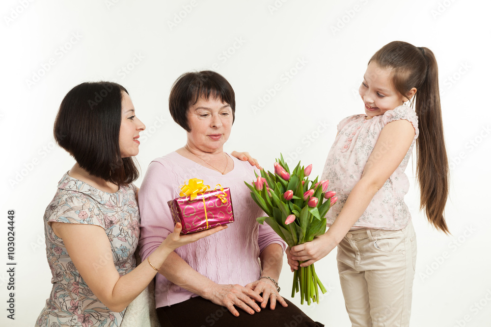 the daughter and the granddaughter give a bouquet the daughter and the granddaughter give a bouquet