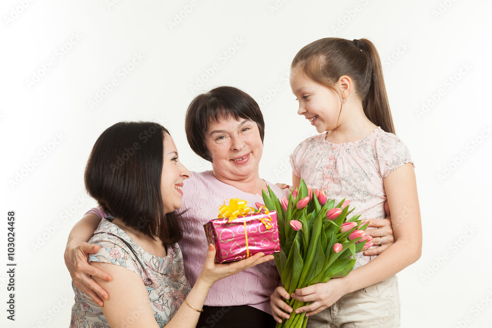 the daughter and the granddaughter give a bouquet the daughter and the granddaughter give a bouquet